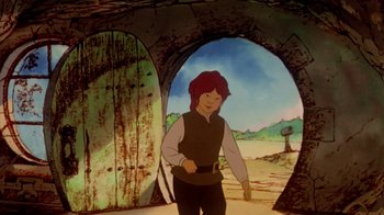 Movie still from “The Lord of the Rings” (1978), directed by Ralph Bakshi – A man standing in front of an opening in a cave; Medium shot, Low angle