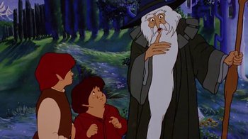 Movie still from “The Lord of the Rings” (1978), directed by Ralph Bakshi – A group of people standing next to each other in front of a forest; Medium shot, Over the shoulder angle