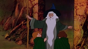 Movie still from “The Lord of the Rings” (1978), directed by Ralph Bakshi – A cartoon picture of gandalf the wizard and two young boys; Medium shot, Low angle