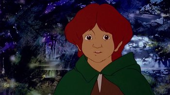 Movie still from “The Lord of the Rings” (1978), directed by Ralph Bakshi – A cartoon of a boy with red hair and a green cape; Close Up shot, High angle
