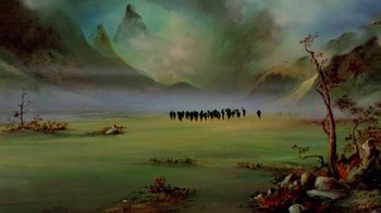 Movie still from “The Lord of the Rings” (1978), directed by Ralph Bakshi – A group of people walking across a lush green field; Extreme Wide shot, High angle