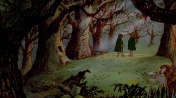 Movie still from “The Lord of the Rings” (1978), directed by Ralph Bakshi – Two people standing in the middle of a forest; Wide shot, High angle