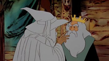Movie still from “The Lord of the Rings” (1978), directed by Ralph Bakshi – A cartoon of a wizard looking at a king; Close Up shot, Over the shoulder angle