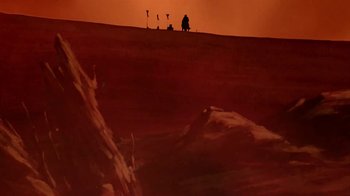 Movie still from “The Lord of the Rings” (1978), directed by Ralph Bakshi – A person standing on top of a hill at sunset; Extreme Wide shot, Low angle