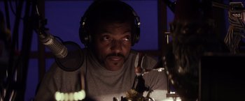 Movie still from “The Lords of Salem” (2012), directed by Rob Zombie – A man with headphones is sitting in front of a microphone; Close Up shot, Low angle