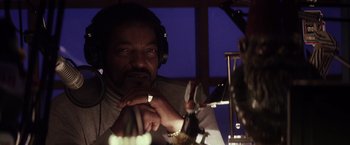 Movie still from “The Lords of Salem” (2012), directed by Rob Zombie – A man with headphones on looking at a microphone; Close Up shot, Low angle