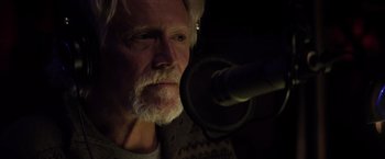 Movie still from “The Lords of Salem” (2012), directed by Rob Zombie – An older man with a beard is listening to a microphone; Close Up shot, Low angle