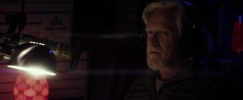 Movie still from “The Lords of Salem” (2012), directed by Rob Zombie – An older man with white hair and a goatee looking out a window; Close Up shot, Low angle