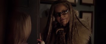 Movie still from “The Lords of Salem” (2012), directed by Rob Zombie – A woman with dreads and glasses looking into a mirror; Close Up shot, Over the shoulder angle