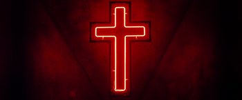 Movie still from “The Lords of Salem” (2012), directed by Rob Zombie – A red neon cross sign lit up on a red wall; Extreme Close Up shot, Low angle