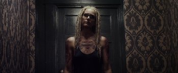 Movie still from “The Lords of Salem” (2012), directed by Rob Zombie – A woman with dreads standing in front of a door; Close Up shot, Low angle