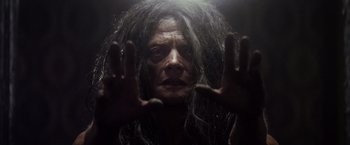 Movie still from “The Lords of Salem” (2012), directed by Rob Zombie – An old man with long grey hair is holding his hands up; Close Up shot, Low angle