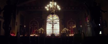 Movie still from “The Lords of Salem” (2012), directed by Rob Zombie – A stained glass window in a church lit up by candles; Extreme Wide shot, Low angle