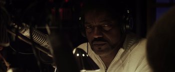 Movie still from “The Lords of Salem” (2012), directed by Rob Zombie – A man wearing headphones and looking at the camera; Close Up shot, Low angle