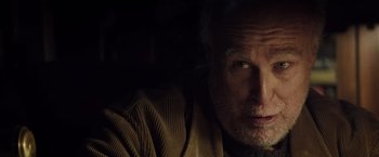 Movie still from “The Lords of Salem” (2012), directed by Rob Zombie – An older man is looking at the camera; Close Up shot, Over the shoulder angle