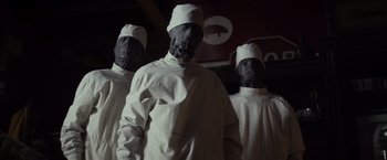 Movie still from “The Lords of Salem” (2012), directed by Rob Zombie – A group of people in white gowns and white hats; Medium shot, Low angle