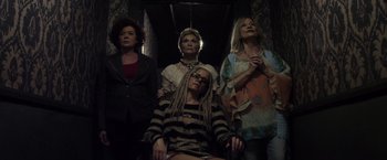Movie still from “The Lords of Salem” (2012), directed by Rob Zombie – A group of women standing next to each other in a room; Medium shot, Overhead angle