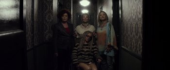 Movie still from “The Lords of Salem” (2012), directed by Rob Zombie – A group of women standing next to each other in an elevator; Wide shot, High angle