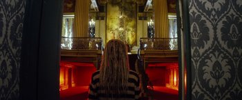 Movie still from “The Lords of Salem” (2012), directed by Rob Zombie – A woman sitting in a church looking at a cross; Wide shot, Low angle