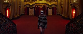 Movie still from “The Lords of Salem” (2012), directed by Rob Zombie – A woman in a striped shirt standing in front of a stage; Wide shot, High angle