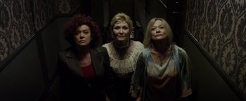 Movie still from “The Lords of Salem” (2012), directed by Rob Zombie – A group of women standing next to each other in a room; Medium shot, High angle
