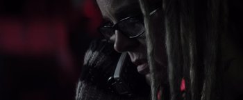 Movie still from “The Lords of Salem” (2012), directed by Rob Zombie – A person with dreads talking on a phone; Close Up shot, Low angle