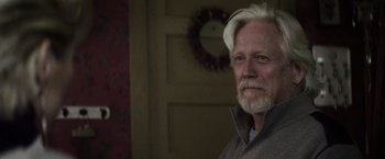 Movie still from “The Lords of Salem” (2012), directed by Rob Zombie – An older man with white hair and a gray beard; Close Up shot, Over the shoulder angle