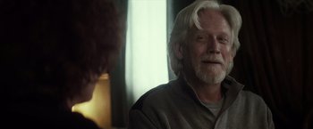 Movie still from “The Lords of Salem” (2012), directed by Rob Zombie – An older man with white hair sitting at a table; Close Up shot, Over the shoulder angle