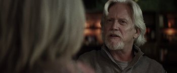 Movie still from “The Lords of Salem” (2012), directed by Rob Zombie – An older man with white hair talking to a younger woman; Close Up shot, Over the shoulder angle