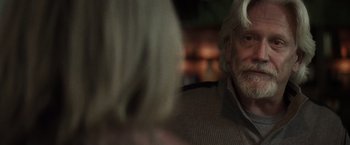 Movie still from “The Lords of Salem” (2012), directed by Rob Zombie – An older man and a young woman sitting at a table; Close Up shot, Over the shoulder angle