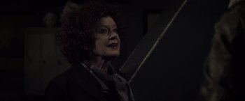 Movie still from “The Lords of Salem” (2012), directed by Rob Zombie – An older woman with red hair and a plaid scarf; Close Up shot, Low angle