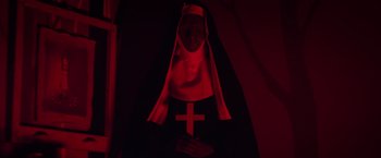 Movie still from “The Lords of Salem” (2012), directed by Rob Zombie – A nun with a cross on her head and hands folded in front; Medium shot, Low angle