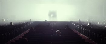Movie still from “The Lords of Salem” (2012), directed by Rob Zombie – People are sitting in a theater watching a performance; Extreme Wide shot, High angle