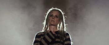 Movie still from “The Lords of Salem” (2012), directed by Rob Zombie – A woman with dreadlocks is standing in the dark; Close Up shot, Low angle