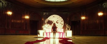 Movie still from “The Lords of Salem” (2012), directed by Rob Zombie – A woman standing in front of a stage with a moon on it; Wide shot, Low angle