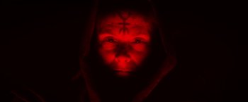 Movie still from “The Lords of Salem” (2012), directed by Rob Zombie – A person with a red light on their face; Close Up shot, High angle