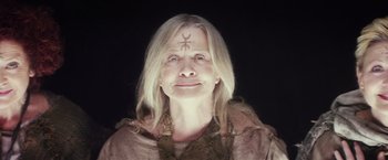 Movie still from “The Lords of Salem” (2012), directed by Rob Zombie – An older woman with long blonde hair wearing a brown jacket; Close Up shot, Low angle