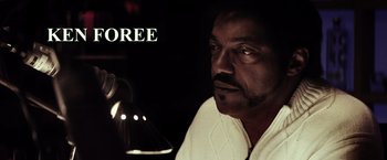 Movie still from “The Lords of Salem” (2012), directed by Rob Zombie – A man in a white shirt is looking at the camera; Extreme Close Up shot, High angle