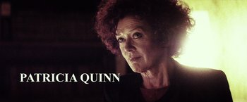 Movie still from “The Lords of Salem” (2012), directed by Rob Zombie – An older woman with curly red hair looking at the camera; Close Up shot, Low angle