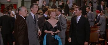 Movie still from “The Lost World” (1960), directed by Irwin Allen – A group of people standing in a room; Medium shot, Low angle