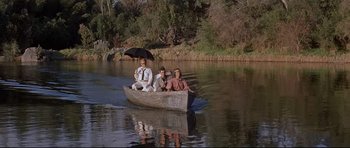 Movie still from “The Lost World” (1960), directed by Irwin Allen – Three men are in a boat on a river; Wide shot, High angle