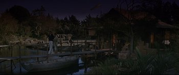Movie still from “The Lost World” (1960), directed by Irwin Allen – A night scene of a river and a house; Extreme Wide shot, High angle