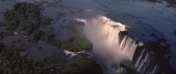 Movie still from “The Lost World” (1960), directed by Irwin Allen – A view of a body of water and a waterfall; Extreme Wide shot, High angle