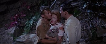 Movie still from “The Lost World” (1960), directed by Irwin Allen – Two men and a woman holding a lamb; Medium shot, High angle