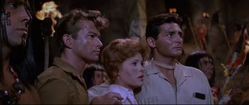 Movie still from “The Lost World” (1960), directed by Irwin Allen – A group of people standing next to each other in a room; Medium shot, Low angle