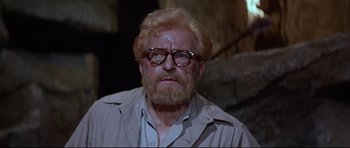 Movie still from “The Lost World” (1960), directed by Irwin Allen – An older man with a beard and glasses; Close Up shot, Low angle