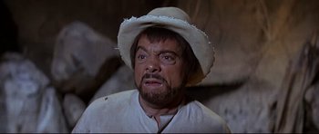 Movie still from “The Lost World” (1960), directed by Irwin Allen – A man with a beard wearing a white hat; Close Up shot, Low angle
