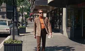 Movie still from “The Love Bug” (1969), directed by Robert Stevenson – A man walking down the street holding a book; Wide shot, Low angle
