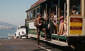 Movie still from “The Love Bug” (1969), directed by Robert Stevenson – A group of people riding on a trolley bus; Wide shot, Low angle