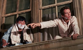 Movie still from “The Love Bug” (1969), directed by Robert Stevenson – Two men are shaving each other outside of a window; Medium shot, Low angle